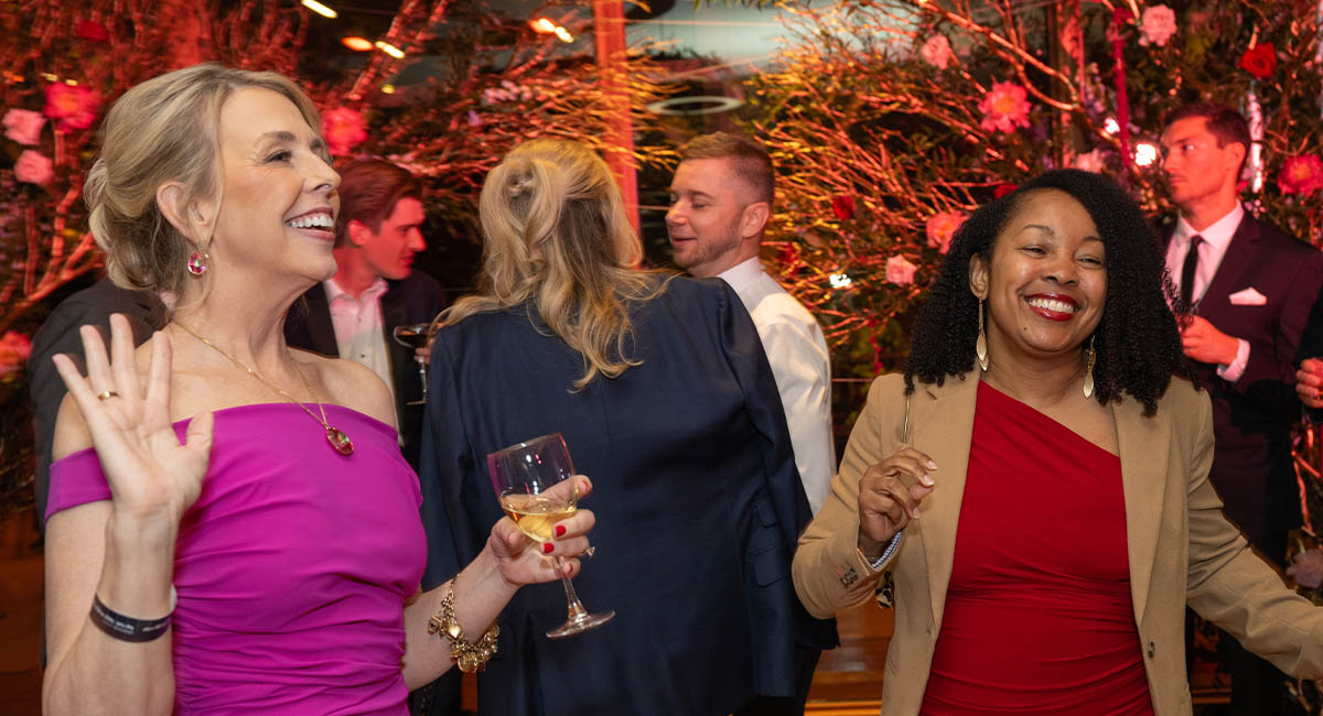 Two women enjoying drinks and dancing at Ravinia's Music Matters fundraising event